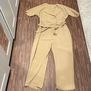 Asos jumpsuit .SZ 8 features fabric belt, front zip and snaps closure.